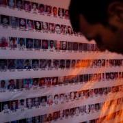 Man looking at photos of people disappeared in Nepal's civil war