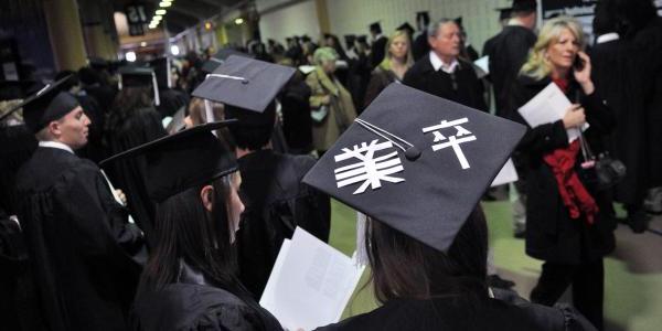 Graduates in subway corridor