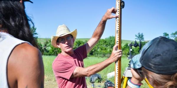 Archaeological field school professor with students