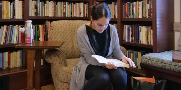 Student reading book in library