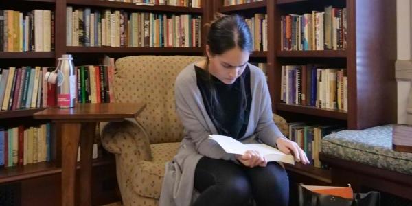 Student reading book in library