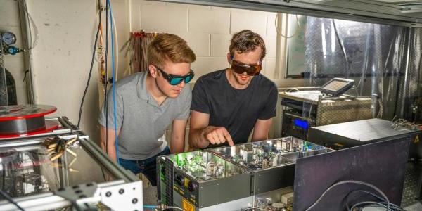 Two students working at a laser table