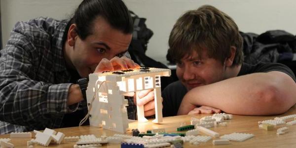 Two students work on a Lego lighting project during their architectural lighting design class