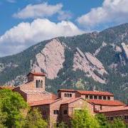 top of a campus building with Flatirons in the background