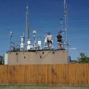 Seonsik Yun and Doug Day stand on the roof of La Casa, an air quality research site in Denver.