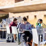 students working at tables outside