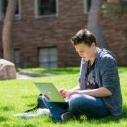 student working on laptop outside