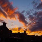 Silhouette of campus buildings with sunset in background