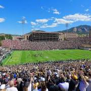 Fans cheering at CU football game at Folsom Field