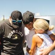 Family of three embraces during move-in