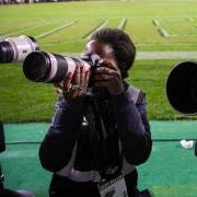 students using long lens cameras on the sideline of a Buffs football game