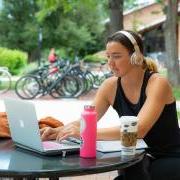 Student studying on laptop outside